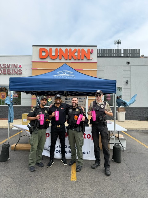 PPP Donuts Network's owner with local police officers at a Special Olympics Illinois fundraiser outside the Dunkin' and Baskin-Robbins restaurant